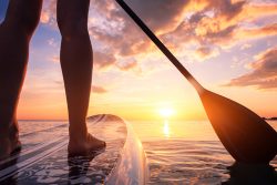Stand,Up,Paddle,Boarding,Or,Standup,Paddleboarding,On,Quiet,Sea