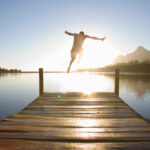 Horizontal,Rear,View,Of,A,Man,Leaping,From,A,Jetty