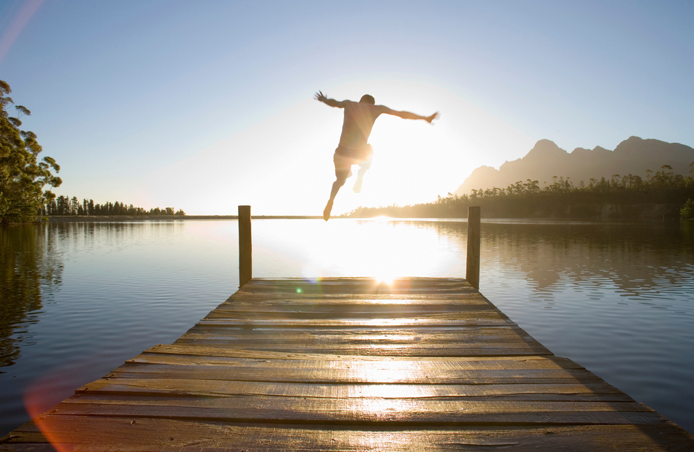 Horizontal,Rear,View,Of,A,Man,Leaping,From,A,Jetty